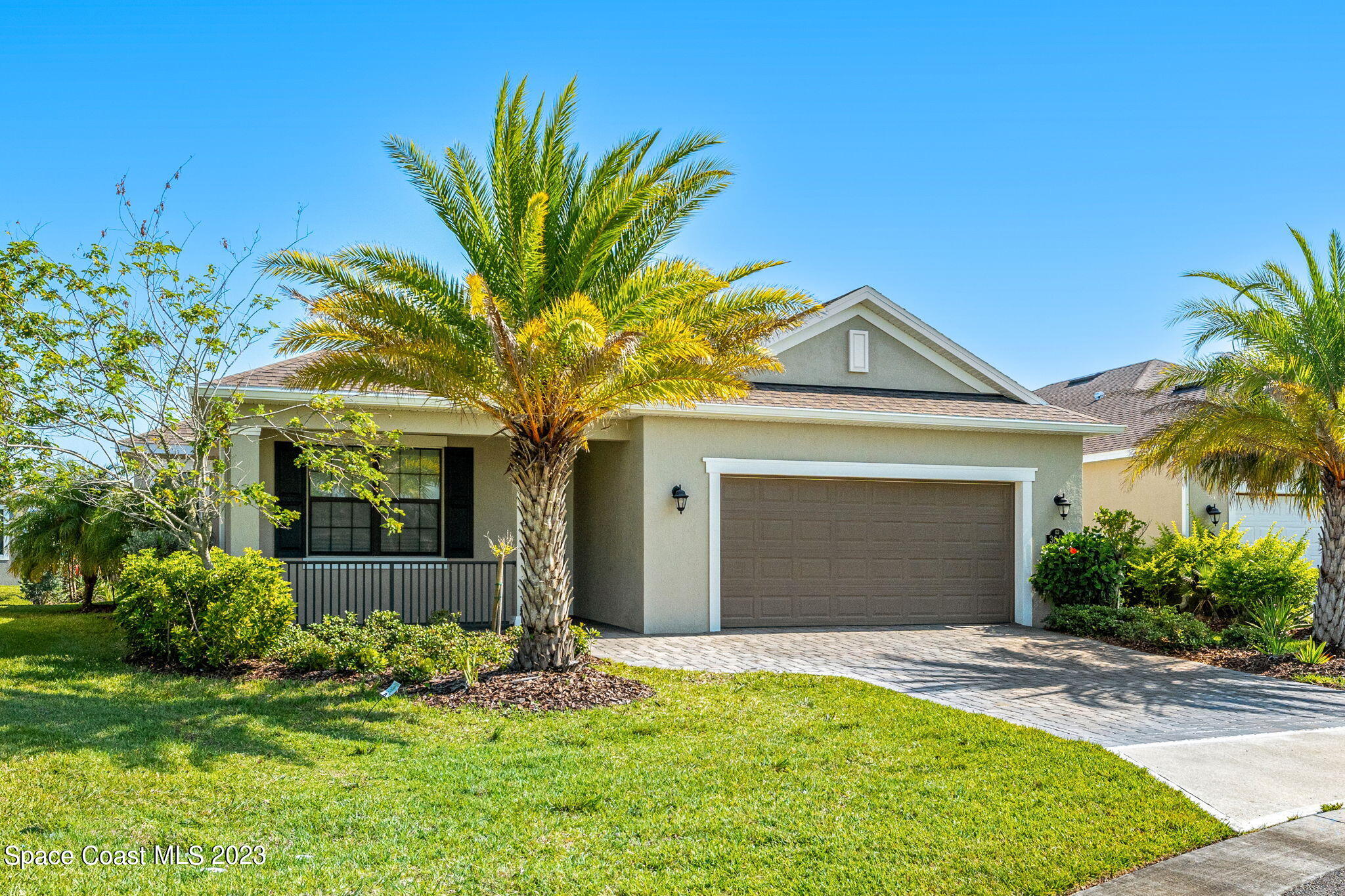 3640 Stabane Place Melbourne, FL 32940 - Photo 5 of 85 a front view of a house with a garden and yard