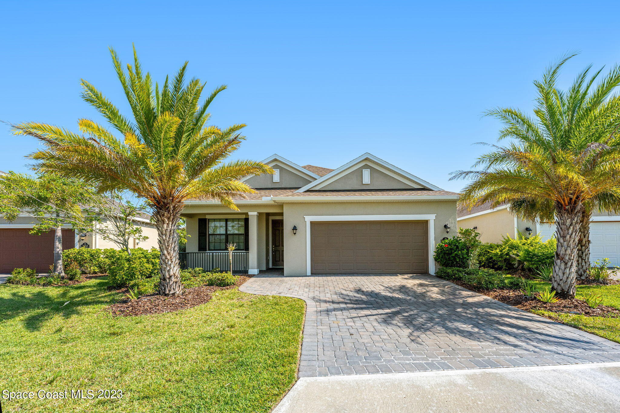 3640 Stabane Place Melbourne, FL 32940 - Photo 59 of 85 a front view of a house with a garden and trees