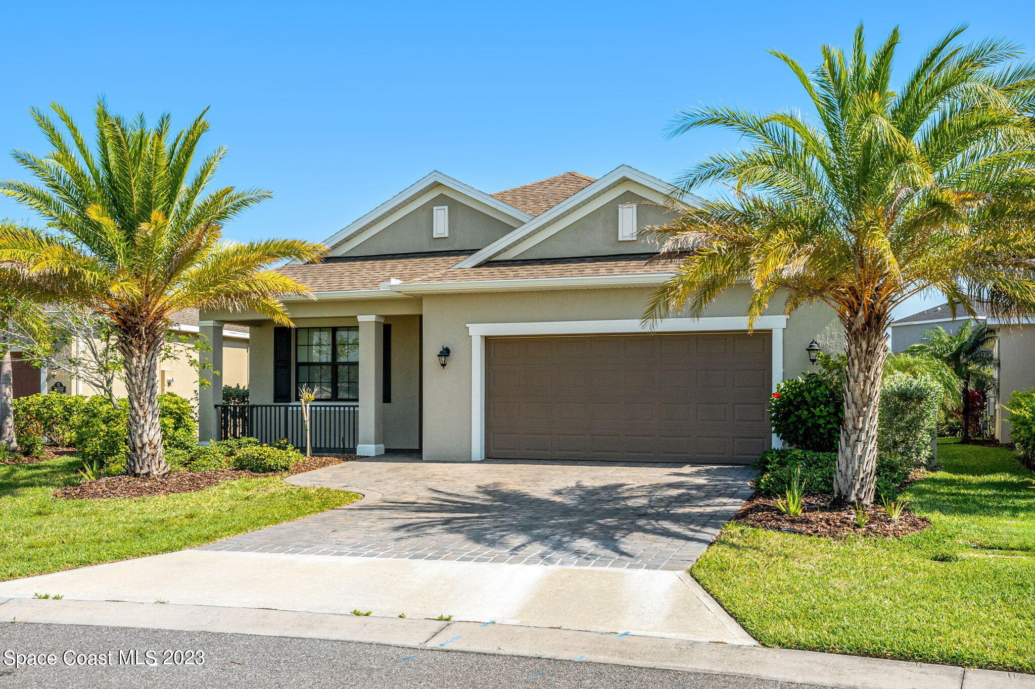 3640 Stabane Place Melbourne, FL 32940 - Photo 6 of 85 a front view of a house with a garden and trees