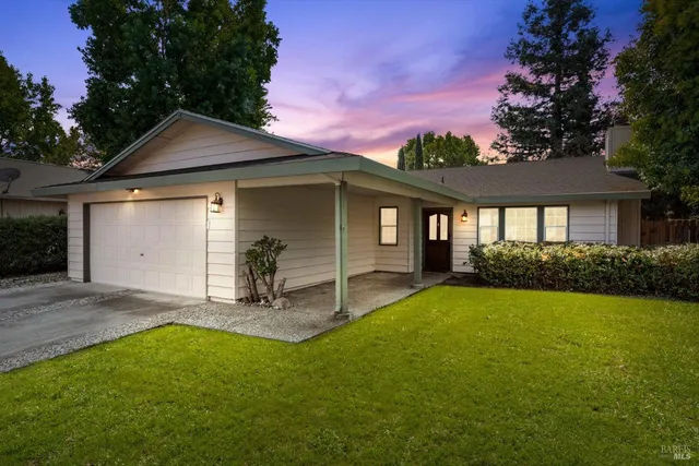 a view of a house with a yard patio and a yard
