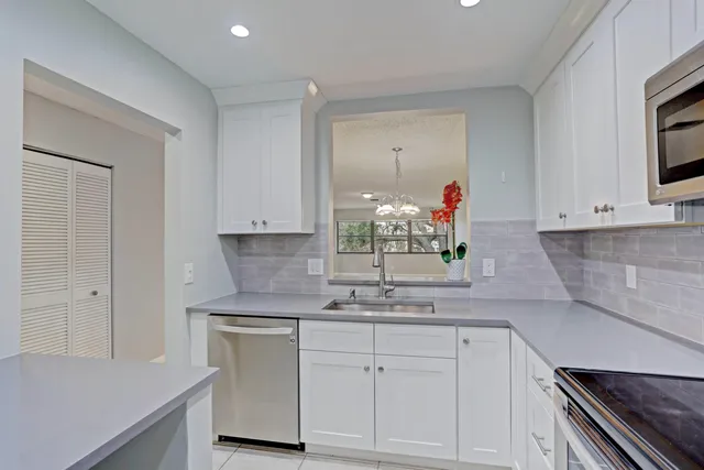 a utility room with cabinets washer and dryer
