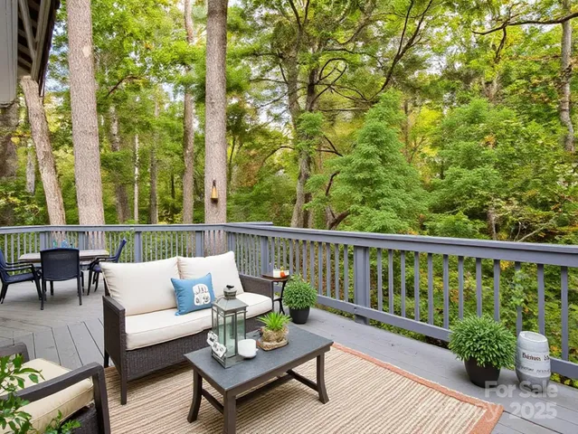 a view of a balcony with wooden floor and outdoor seating