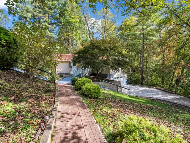 a pathway of a house with a yard