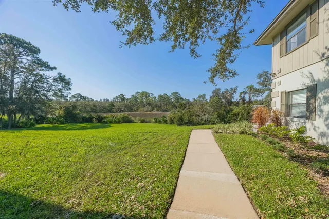 a very nice looking bedroom with a large bed and a chandelier