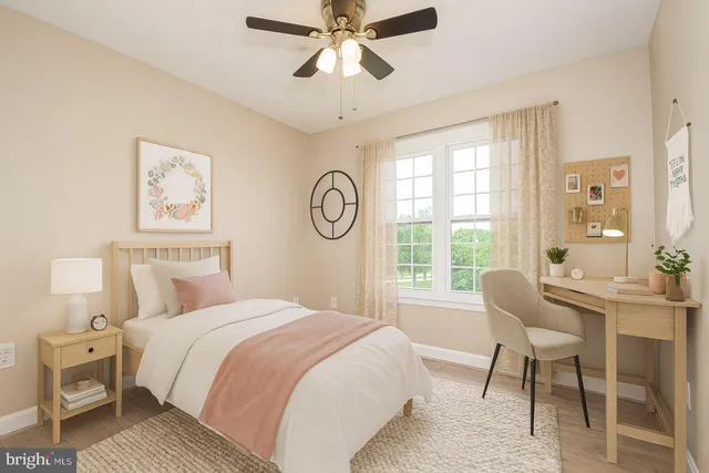 a bedroom with a bed and a large window