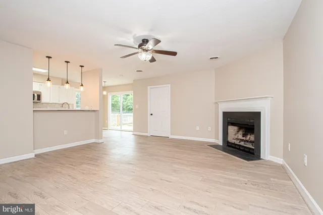 a view of a kitchen with a sink a fireplace and a window