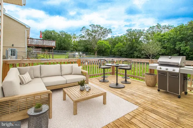 a view of roof deck with couches and sky view