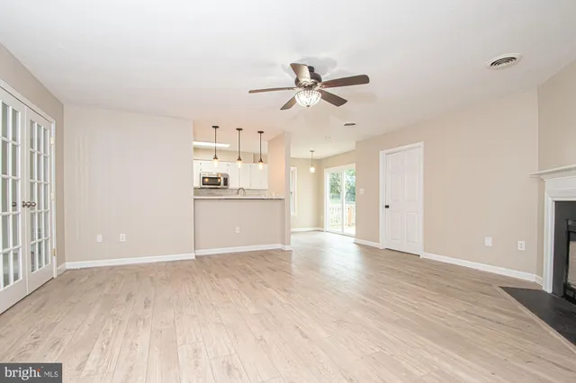 a view of a kitchen with a dishwasher and wooden floor