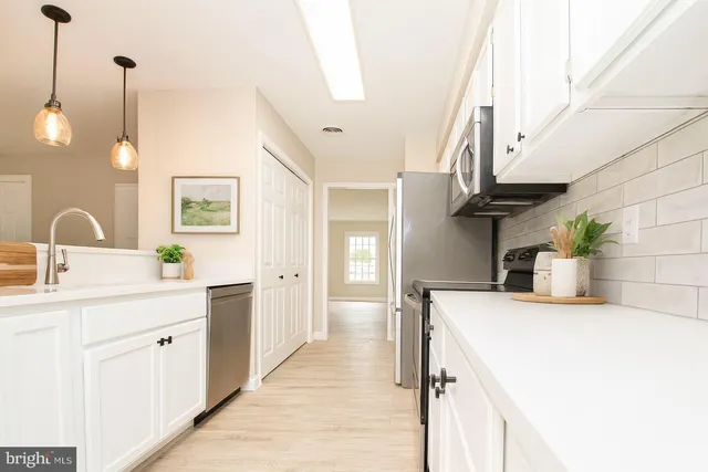 a kitchen with a sink and stove