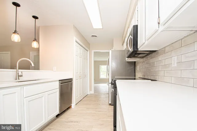 a kitchen with a sink and cabinets