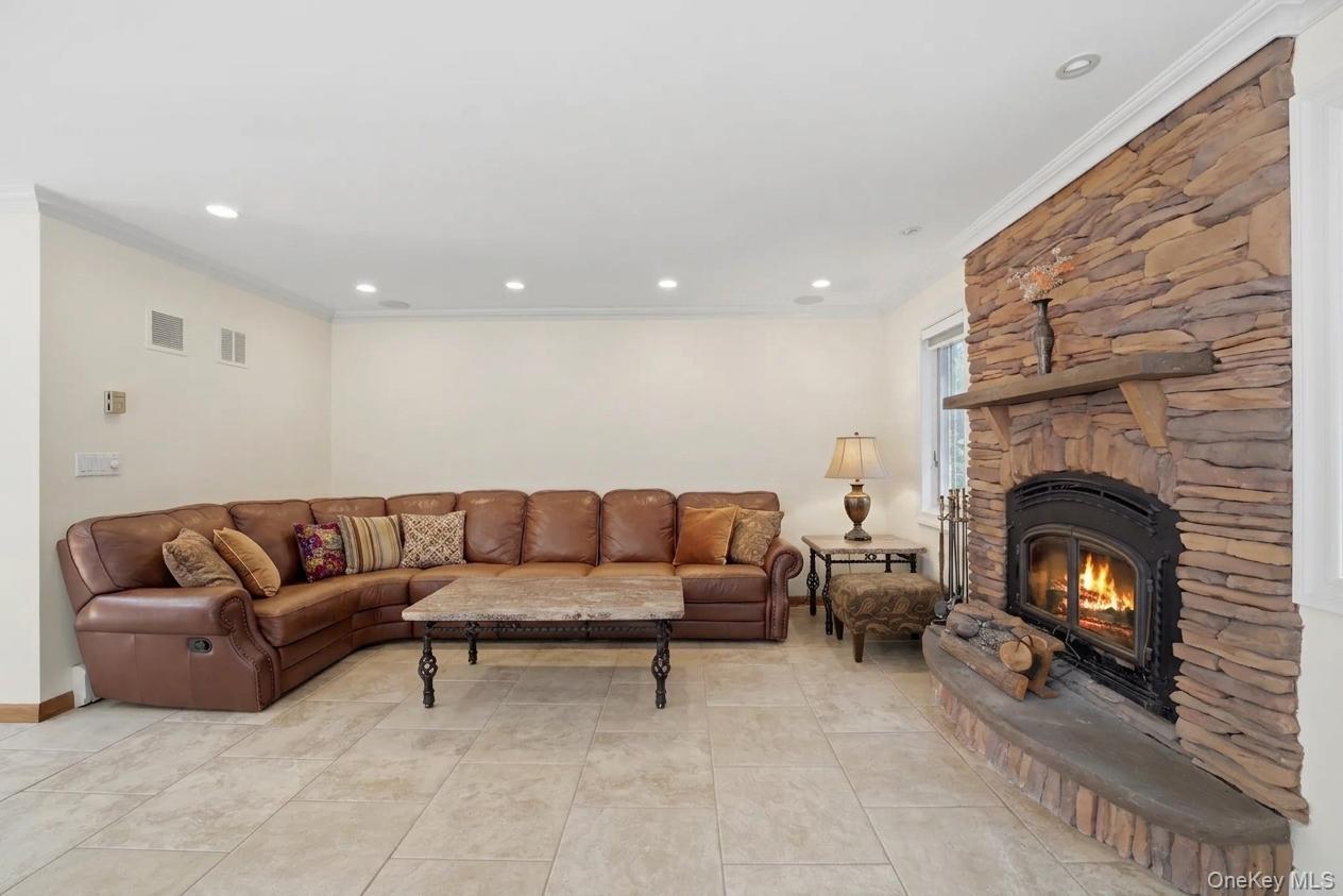 29 Montrose Road Yonkers, NY 10710 - Photo 10 of 39 Stacked stone fireplace with a raised hearth and wood mantel