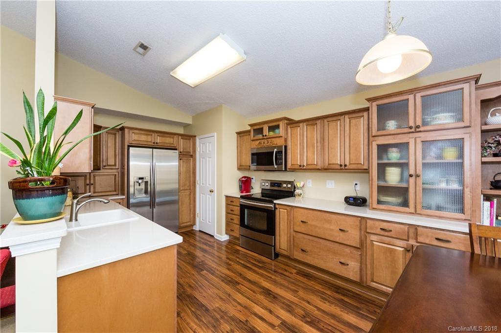 236 Grayland Road Mooresville, NC 28115 - Photo 11 of 27 a kitchen with stainless steel appliances a sink a stove and a wooden floors