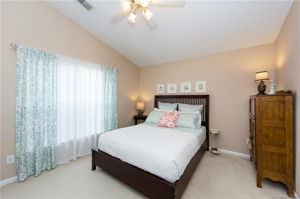 236 Grayland Road Mooresville, NC 28115 - Photo 14 of 27 a bedroom with a bed and a chandelier