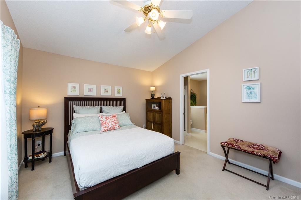 236 Grayland Road Mooresville, NC 28115 - Photo 15 of 27 a bedroom with a bed and a chandelier