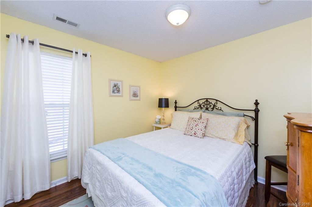 236 Grayland Road Mooresville, NC 28115 - Photo 19 of 27 a bedroom with a bed and wooden floor