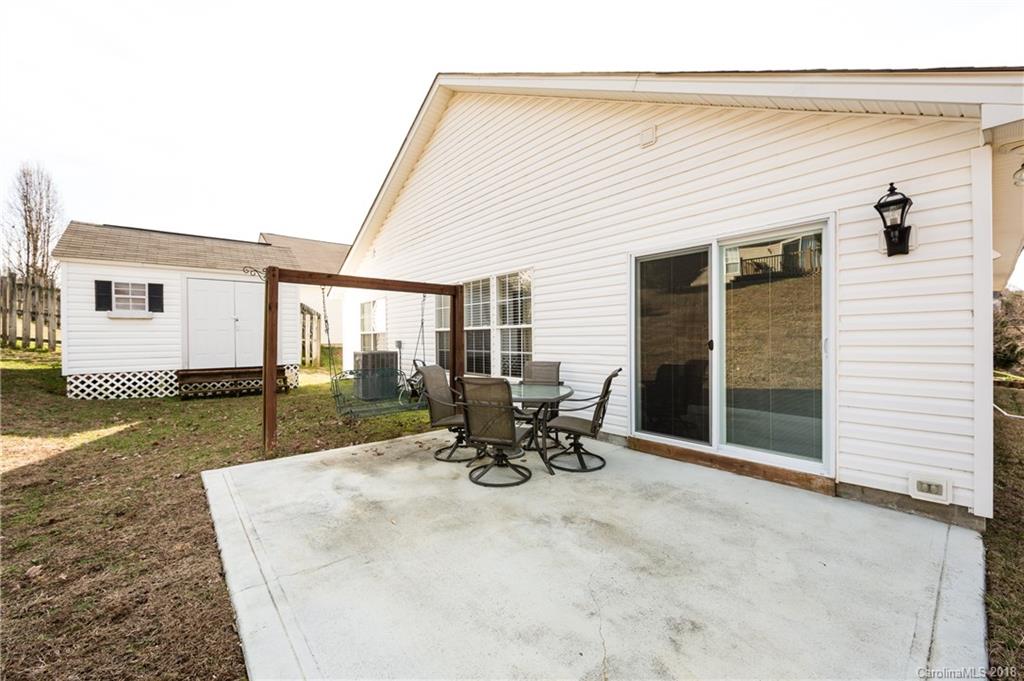 236 Grayland Road Mooresville, NC 28115 - Photo 27 of 27 a view of a patio with table and chairs and floor to ceiling window