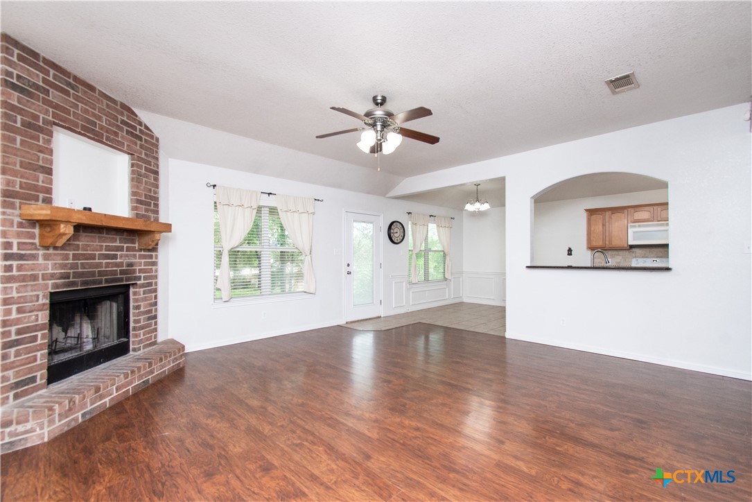 568 Morgan's Point Road Belton, TX 76513 - Photo 3 of 20 a view of an empty room with a fireplace and a window