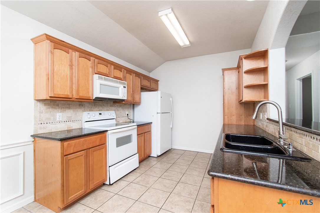 568 Morgan's Point Road Belton, TX 76513 - Photo 8 of 20 a kitchen with stainless steel appliances granite countertop a sink stove and cabinets