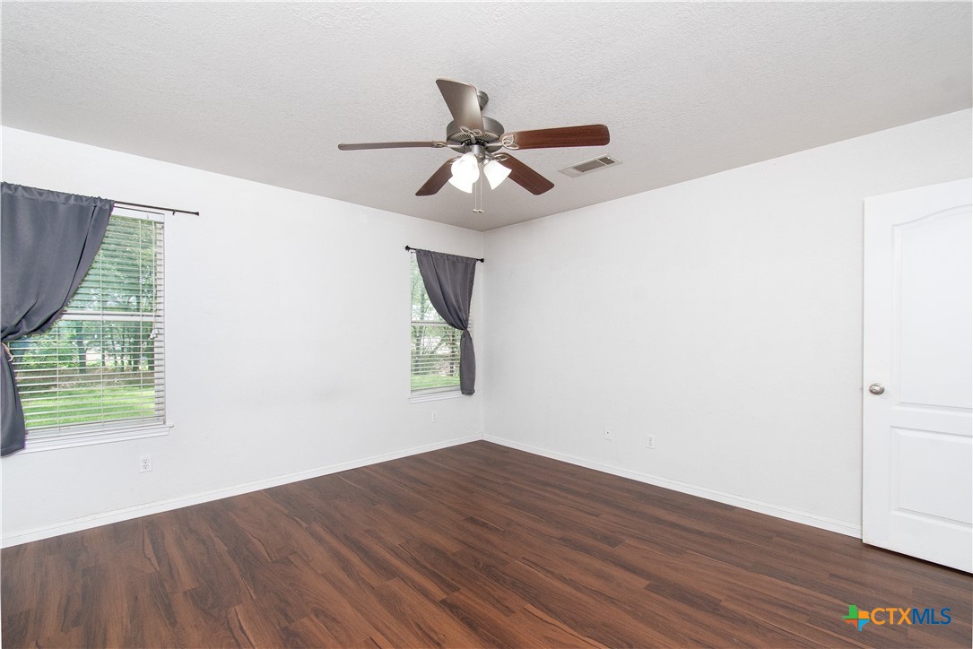 568 Morgan's Point Road Belton, TX 76513 - Photo 10 of 20 a view of an empty room with wooden floor and a window