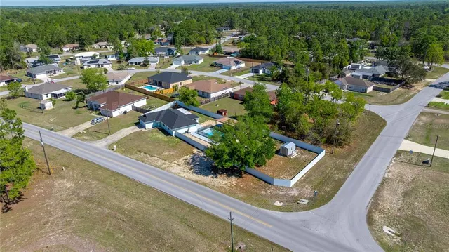 an aerial view of residential houses with outdoor space