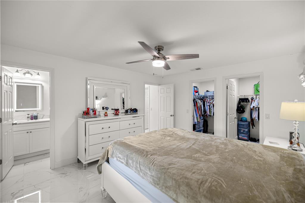 7191 Hemlock Road Ocala, FL 34472 - Photo 14 of 34 a room with a bed and a chandelier