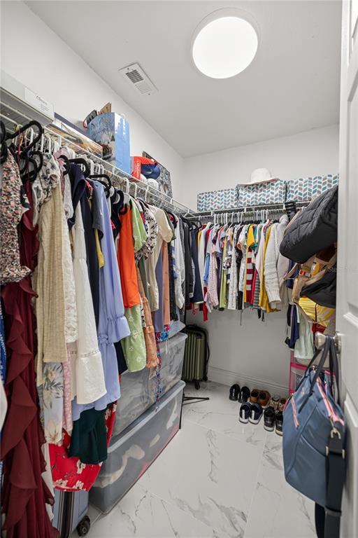 7191 Hemlock Road Ocala, FL 34472 - Photo 16 of 34 a view of walk in closet with clothes and shoes