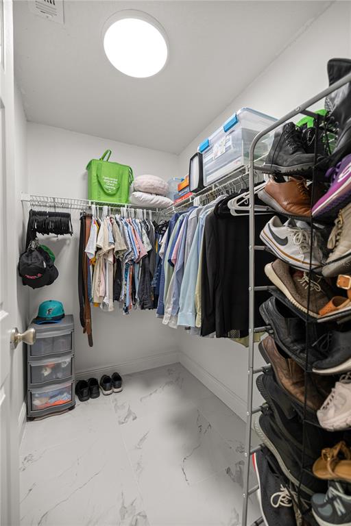 7191 Hemlock Road Ocala, FL 34472 - Photo 17 of 34 a view of walk in closet with clothes and shoes