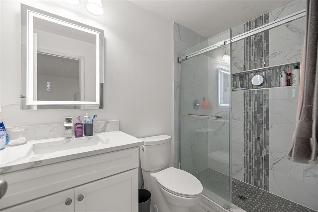 7191 Hemlock Road Ocala, FL 34472 - Photo 18 of 34 a bathroom with a sink a toilet and shower