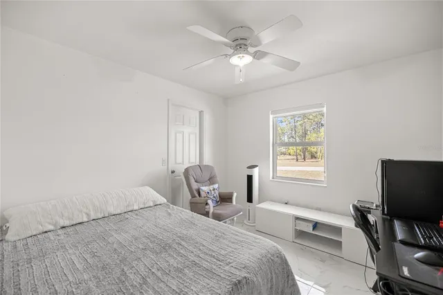 a bedroom with a bed and a chair