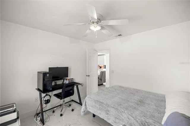 a bedroom with a workspace