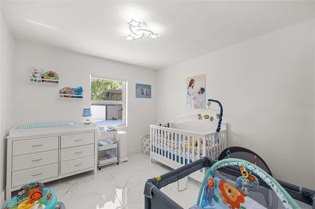 a bedroom with furniture and a window