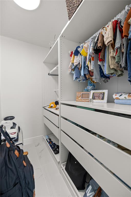 7191 Hemlock Road Ocala, FL 34472 - Photo 23 of 34 a view of walk in closet with clothes and shoes