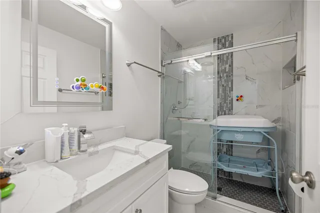 a bathroom with a sink toilet vanity and tub