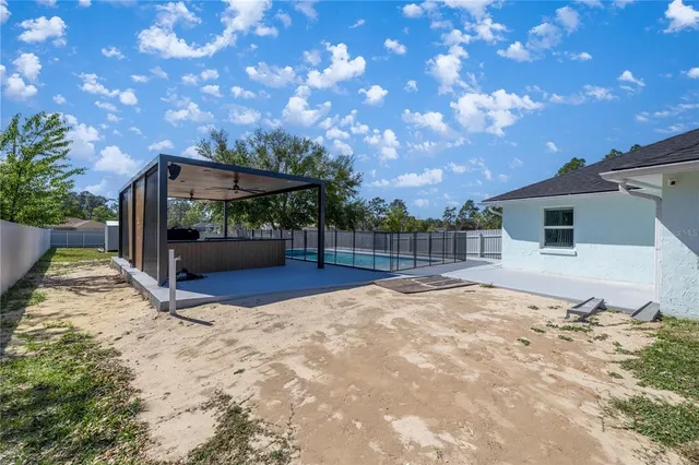 a view of a backyard with large tree