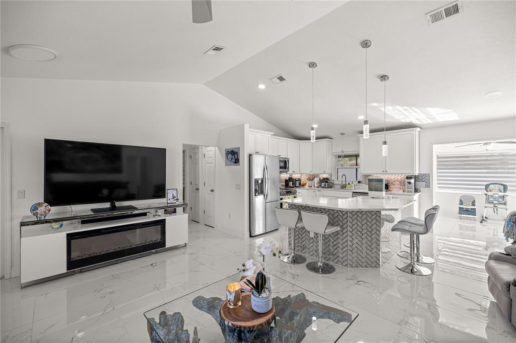 7191 Hemlock Road Ocala, FL 34472 - Photo 8 of 34 a living room with furniture and a flat screen tv