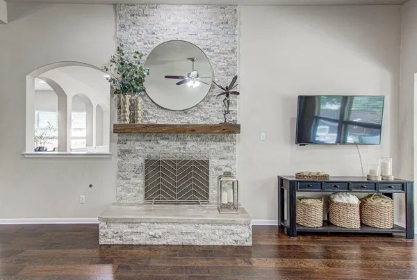 a living room with fireplace furniture and a wooden floor