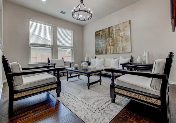 a living room with furniture a rug and a window