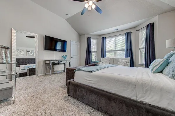 a bedroom with a bed and a flat screen tv