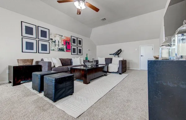 a living room with furniture and a chandelier