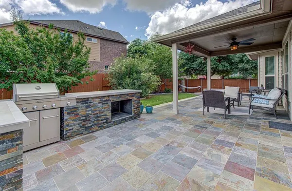a view of a backyard with a patio and a fire pit