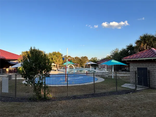 a view of a swimming pool with lounge chairs