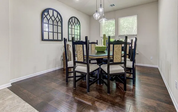 a view of a a dining room with furniture window and wooden floor