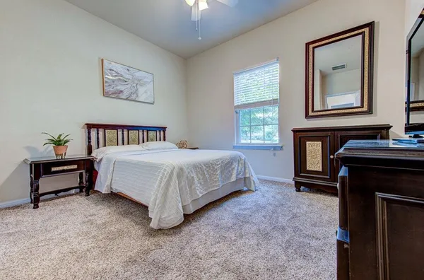a bedroom with a bed and a night stand