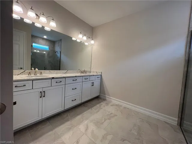 a bathroom with a double vanity sink and a mirror
