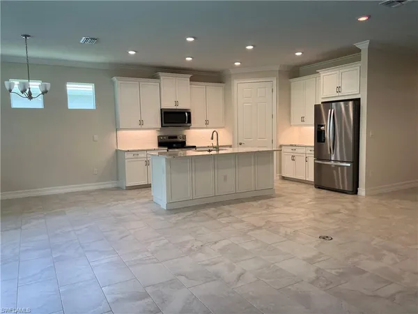 a kitchen with stainless steel appliances a refrigerator and a sink
