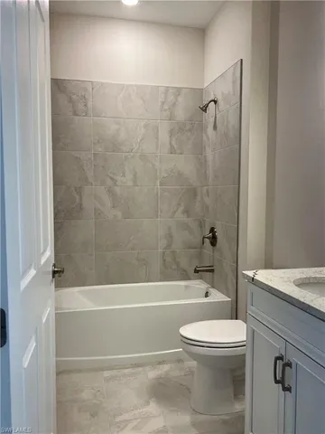 a bathroom with a toilet a sink and shower