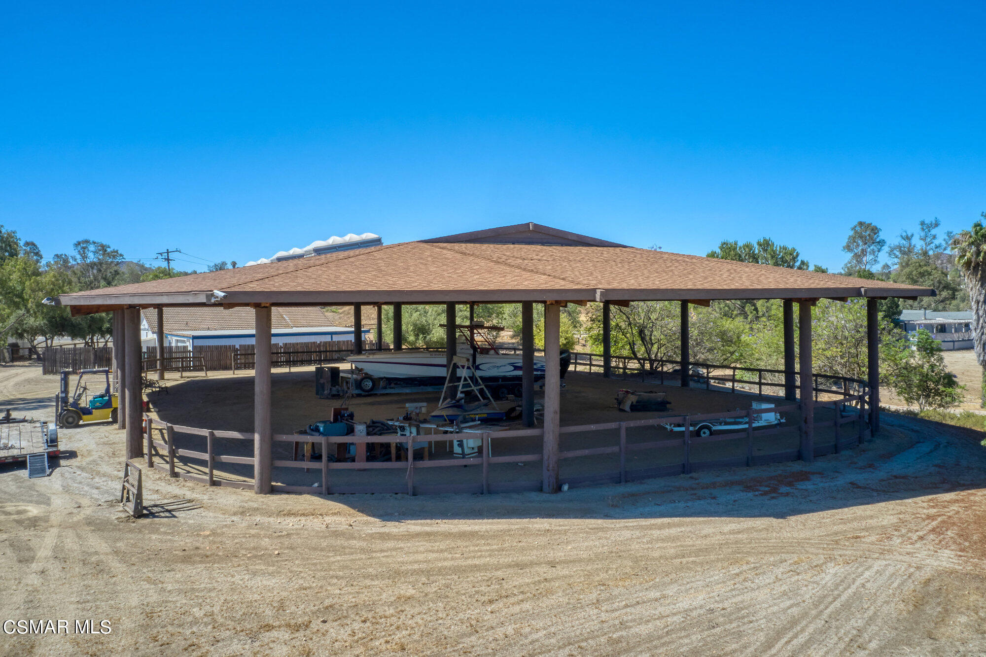 17498 Santa Rosa Mine Road Perris, CA 92570 - Photo 17 of 55 a view of a patio with chairs under an umbrella with wooden floor