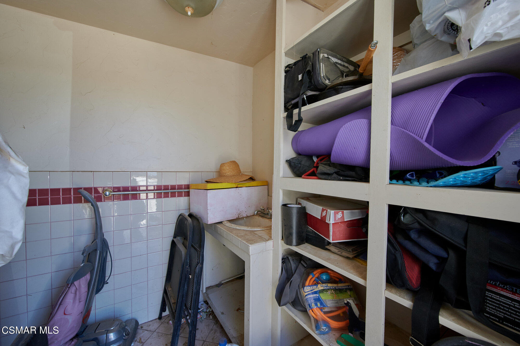 17498 Santa Rosa Mine Road Perris, CA 92570 - Photo 55 of 55 a utility room with lots of clutter and cabinets