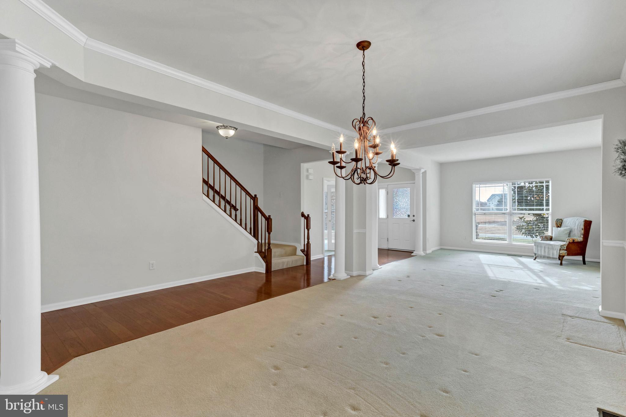 24872 Rivers Edge Road Millsboro, DE 19966 - Photo 11 of 80 a view of a livingroom with a staircase a ceiling fan and a kitchen view