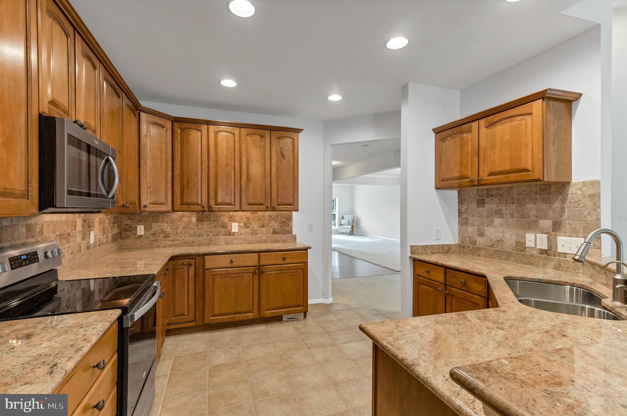 24872 Rivers Edge Road Millsboro, DE 19966 - Photo 19 of 80 a kitchen with a stove sink and cabinets